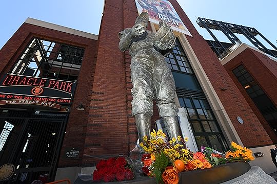 Flowers are left at the foot of a statue of...