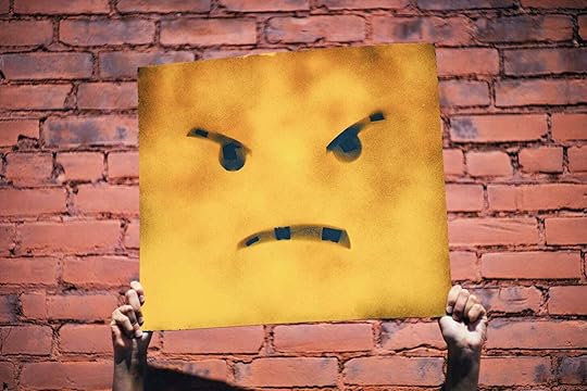 An angry enoji on a piece of yellow card