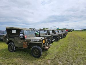 A row of Willy’s jeeps in a rainy UK field