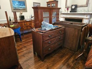 Brown furniture stacked up in a room