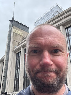 Writer Simon Guerrier outside the department store Barkers in Kensington