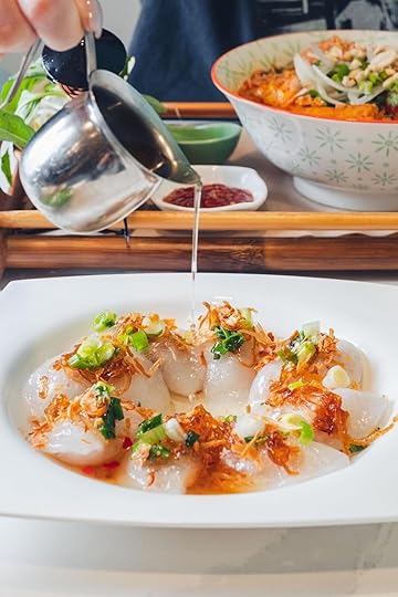 Person pour sauce on dumplings at Banh Mi Tres Bon one of the best places on the dumpling trail richmond