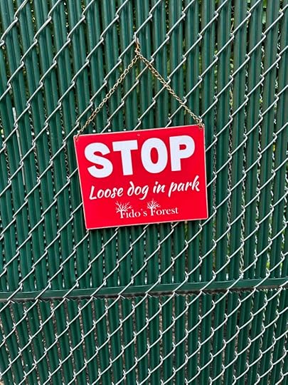 loose dog in park sign