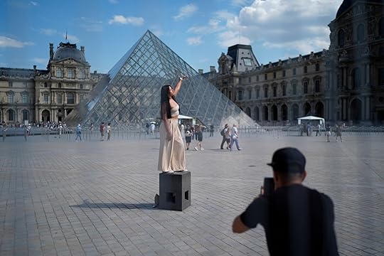 A woman from Mexico poses in the courtyard of the Louvre museum, which is outside the security perimeter set up for the Olympic Games, Friday, July 19, 2024, in Paris, France. (AP Photo/David Goldman)