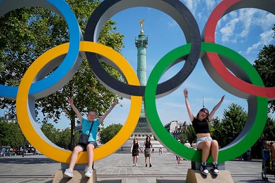 Kids play in Olympic rings set up on Place de la Bastille, Friday, July 19, 2024, in Paris, France. (AP Photo/David Goldman)