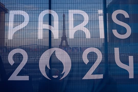 The Eiffel Tower is seen behind a Paris Olympics canvas, from the Trocadero plaza Thursday, July 18, 2024 in Paris. (AP Photo/David Goldman)