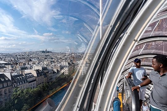 The Sacre Coeur basilica stands in the background, left, as visitors reach the top of the George Pompidou Beaubourg museum ahead of the 2024 Summer Olympics, Sunday, July 21, 2024, in Paris. (AP Photo/David Goldman)