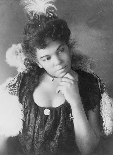 Young African American woman, half-length portrait, facing right, with left hand under chin