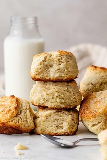 stack of shortcake biscuits with jar of buttermilk in background.
