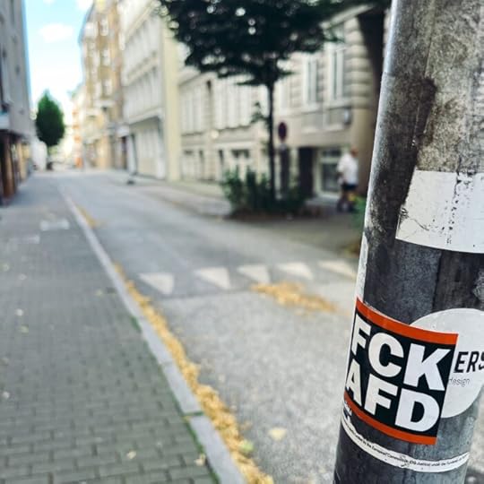 Ein Aufkleber an einem Verkehrsschildmast: 