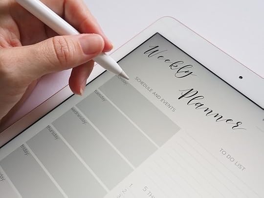 White electronic weekly planner, hand holding stylus