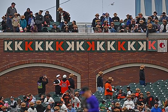 An Oracle Park employee flips over the K sign after...