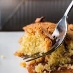 Gala apple cake on a fork ready to for a bite to be taken.