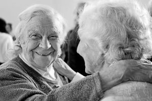 Two elderly women hugging each other
