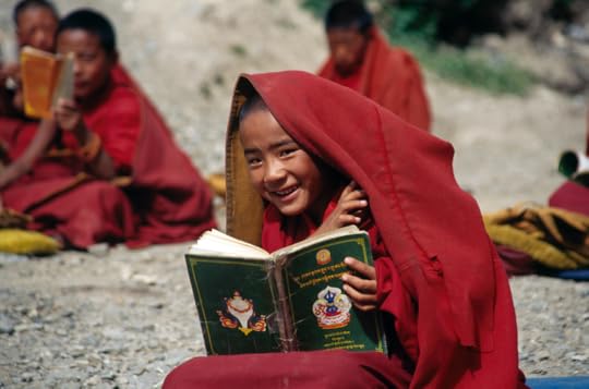 An Asian child reading a book