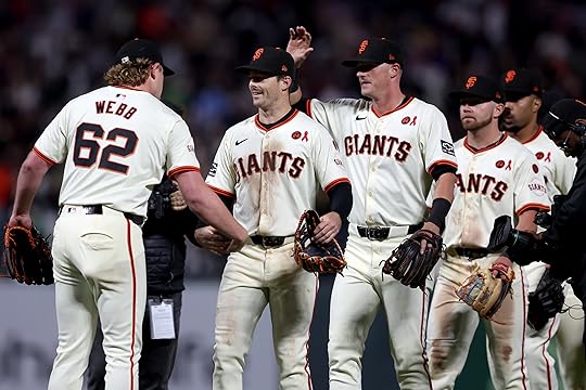 San Francisco Giants starting pitcher Logan Webb (62) and teammates...