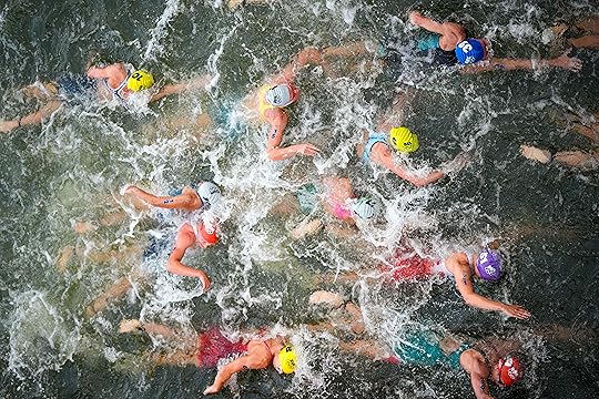Australia’s Natalie Van Coevorden, center, competes in the swim leg...