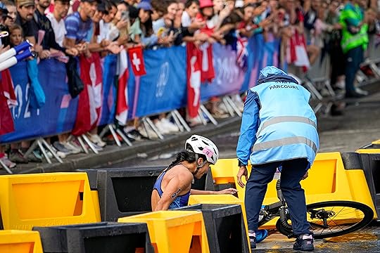 Manami Iijima, of Guam, is helped by staff after crashing...