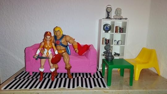 He-Man and Teela sit on the sofa.