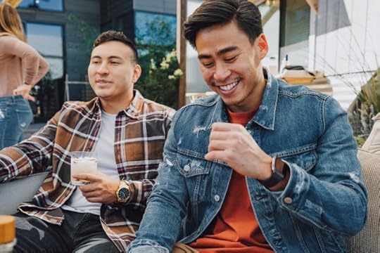 A couple sitting together, laughing. Generate non-toxic positivity