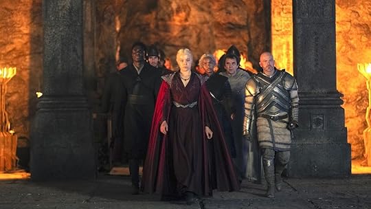 Rhaenyra and her retinue walk through a doorway to dragons on House of the Dragon