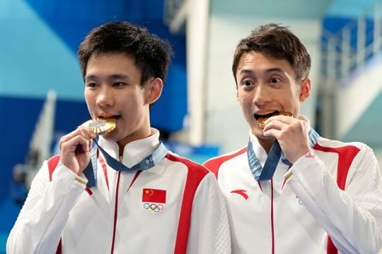 China's Lian Junjie and Yang Hao celebrate on the podium after winning the gold medal in the men's synchronised 10m platform diving final at the 2024 Summer Olympics, Monday, July 29, 2024, in Saint-Denis, France. (AP Photo/Lee Jin-man)