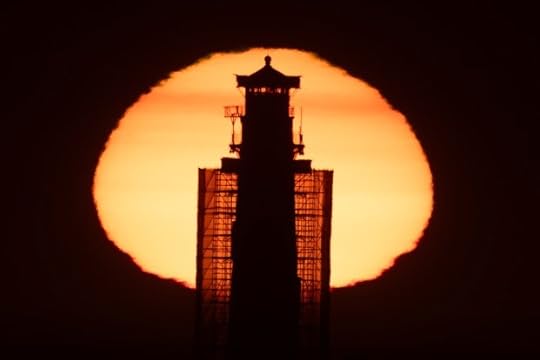 Covered in scaffolding for a $16 million restoration project, the Pigeon Point Lighthouse is silhouetted against the setting sun. Monday, July 3, 2024, in Pescadero, Calif. (Karl Mondon/ Bay Area News Group)