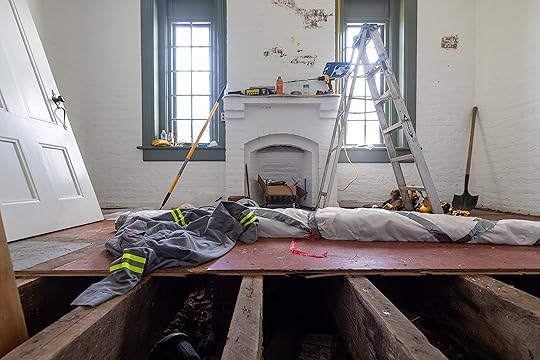 Floorboards are exposed in the ground floor workspace of the...