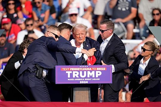 Republican presidential candidate former President Donald Trump is helped off...