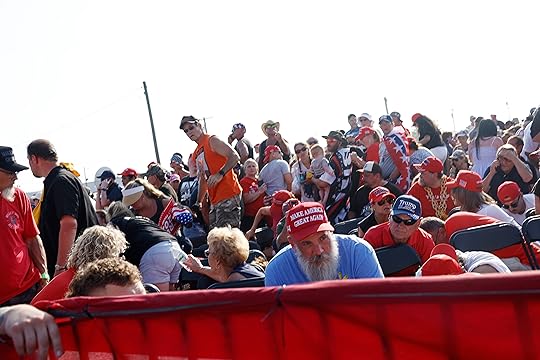 The crowd reacts after shots were fired at republican presidential...