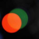 Red Circle on Top of a Green Circle on a Dark Background