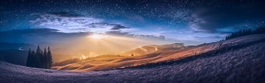 The meeting of day and night in a mountain valley with wonderful gold light on a hills and bright stars in a sky.