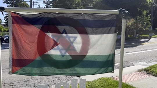 An overlay of a Palestinian flag covering an Israeli flag that has the Star of David covered by a DON'T symbol displayed outside a synagogue in Ann Arbor, MI