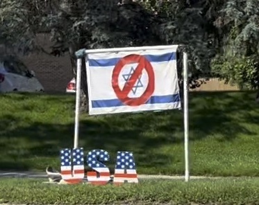an Israeli flag with the Jewish Star covered in a DON'T sign flown over a star-spangled sign reading 