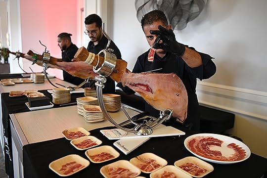A server slices pieces of Fermin Jamon Iberico to serve...