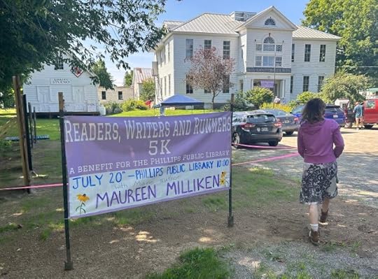 A sign that says Maureen Milliken July 20, with a large white library in the background