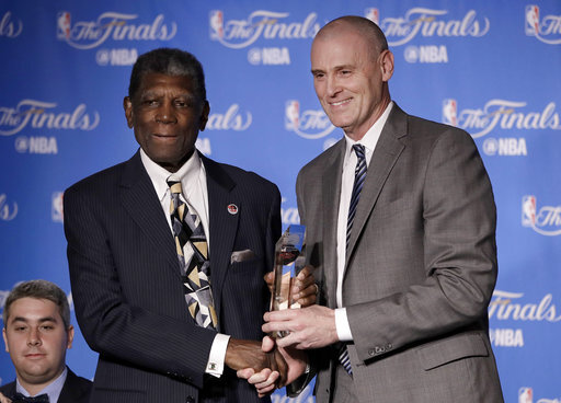 Former Golden State Warriors head coach Al Attles, left, accepts the NBA Coaches Association's Chuck Daly Lifetime Achievement Award from Dallas Mavericks head coach Rick Carlisle before Game 2 of basketball's NBA Finals between the Warriors and the Cleveland Cavaliers in Oakland, Calif., Sunday, June 4, 2017. (AP Photo/Marcio Jose Sanchez)