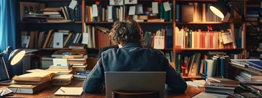 person at desk with books on shelf