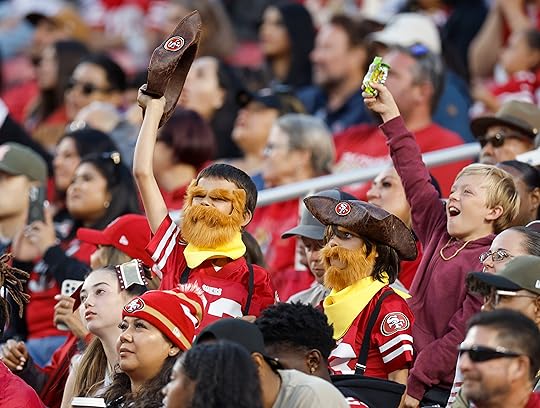 Young San Francisco 49ers fans cheer for their team during...