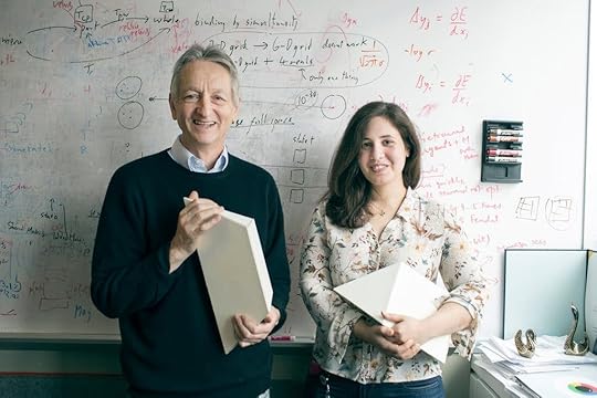 Geoff Hinton and Sara Sabour holding the puzzle pieces