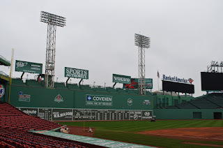 Image of Fenway Park in Boston, MA, in the daytime, of the Green Monster, with towering light poles above wall