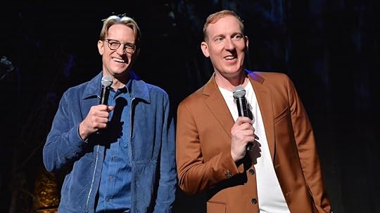 The Rings of Power showrunners standing with microphones in hand