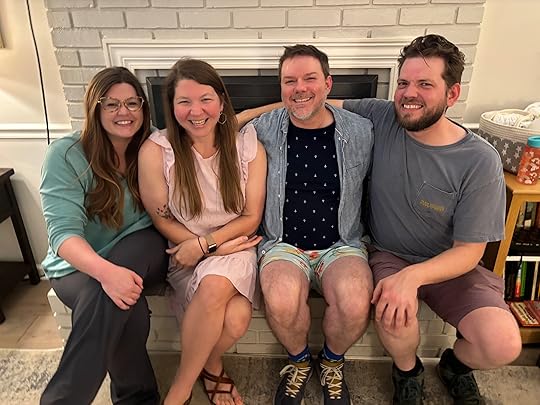 a group of people sitting together smiling