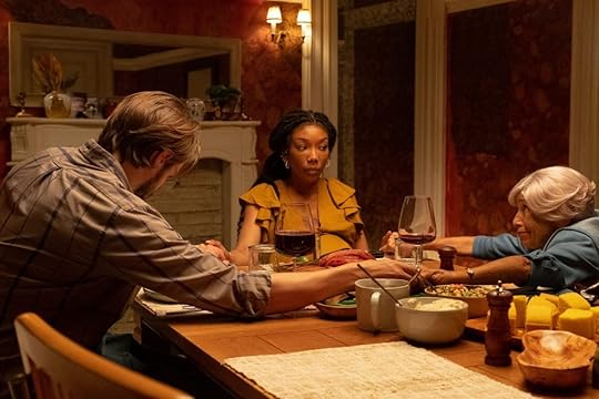 image from the front room of brandy and two others sitting at a dining room table