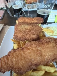Plate of fish and chips with a glass of Guinness