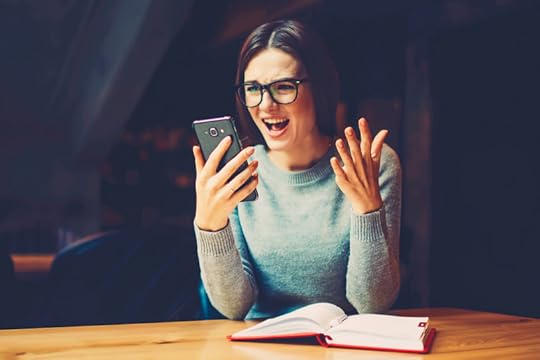 Woman holding a smartphone. Emotions. Surprise