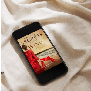 Cellphone showing book cover for Secrets to the Wind