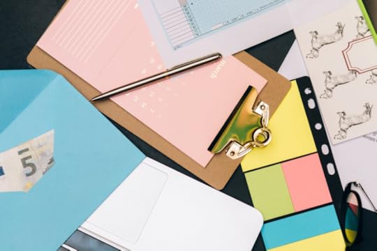 Image: a jumble of papers on a table, indicating many tasks being attempted at once.