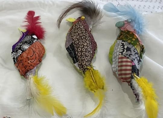 colorful, heavily feathered handmade birds