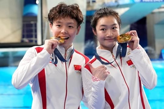 China's Chen Yiwen and Chang Yani hold their gold medal on the podium of the women's synchronised 3m springboard diving final at the 2024 Summer Olympics, Saturday, July 27, 2024, in Saint-Denis, France. (AP Photo/Lee Jin-man)